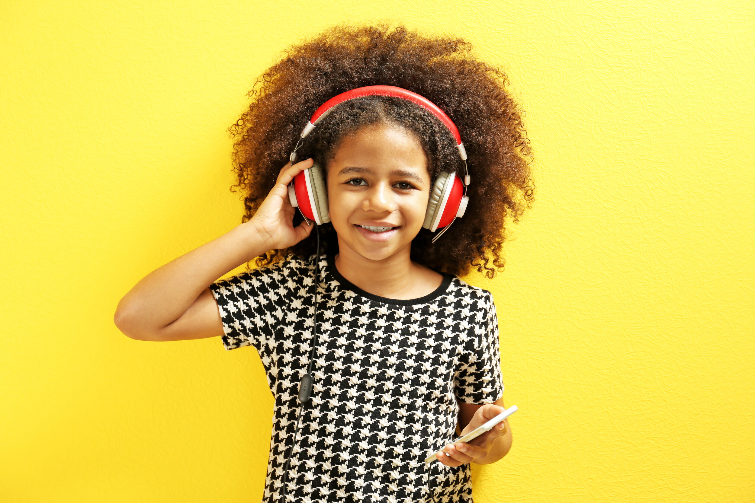 smiling child listening to music in headphones